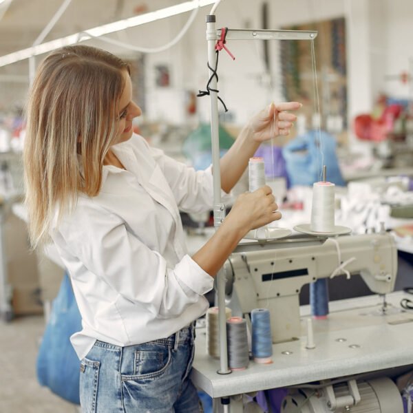 Woman with a thread. Lady in the factory.